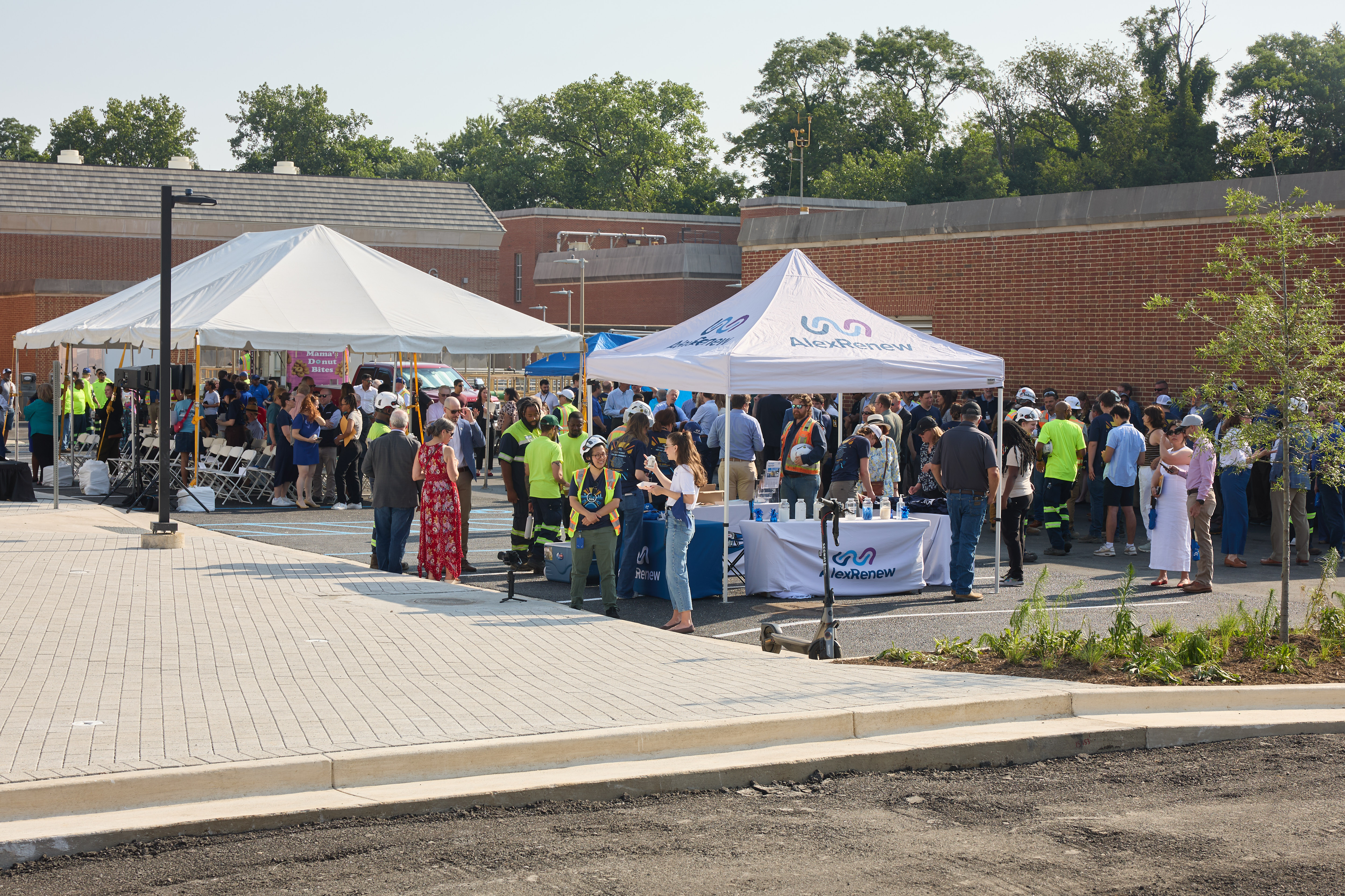 a wide angle shot of tents and people waiting for the start of the event