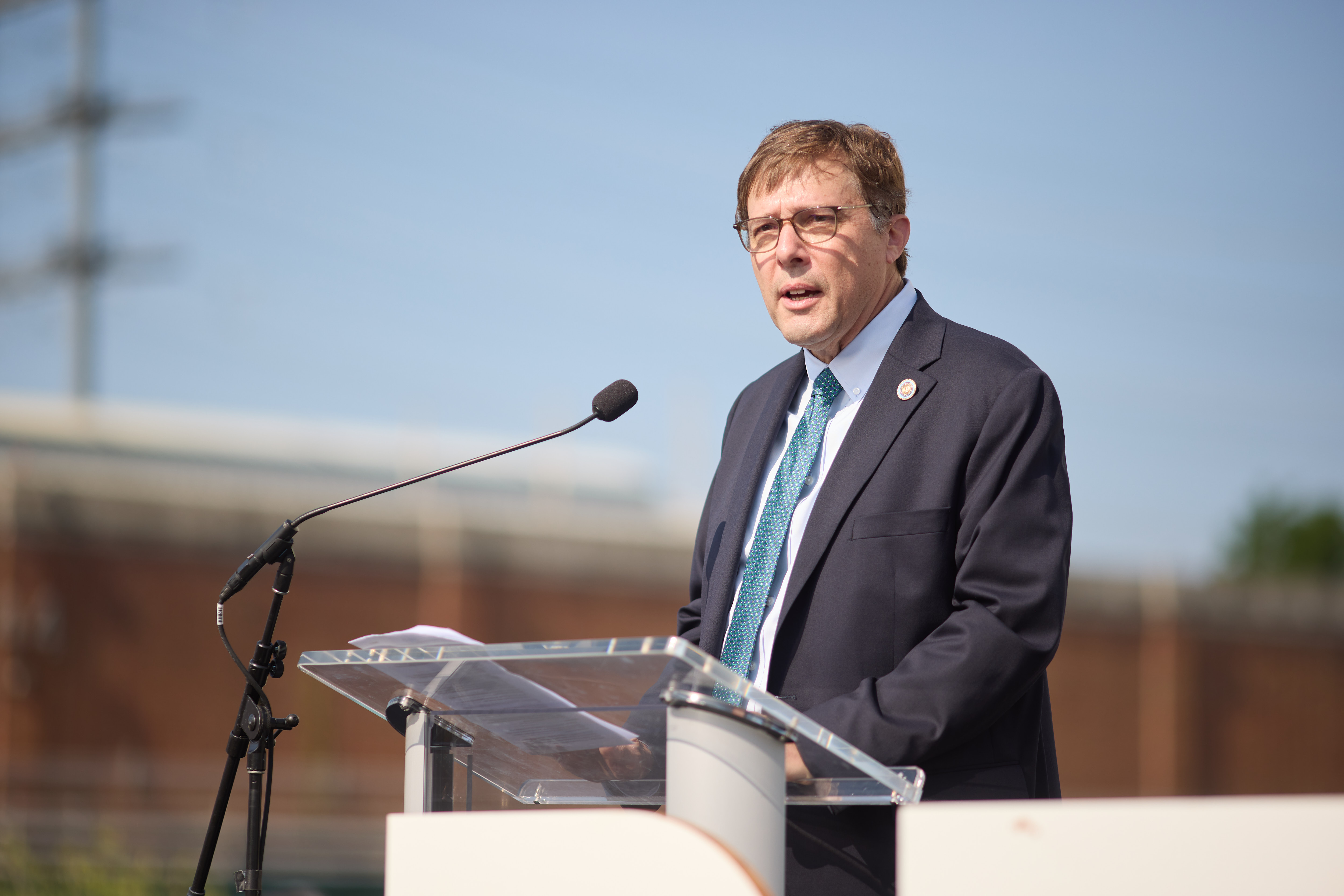 A man in a suit at the podium