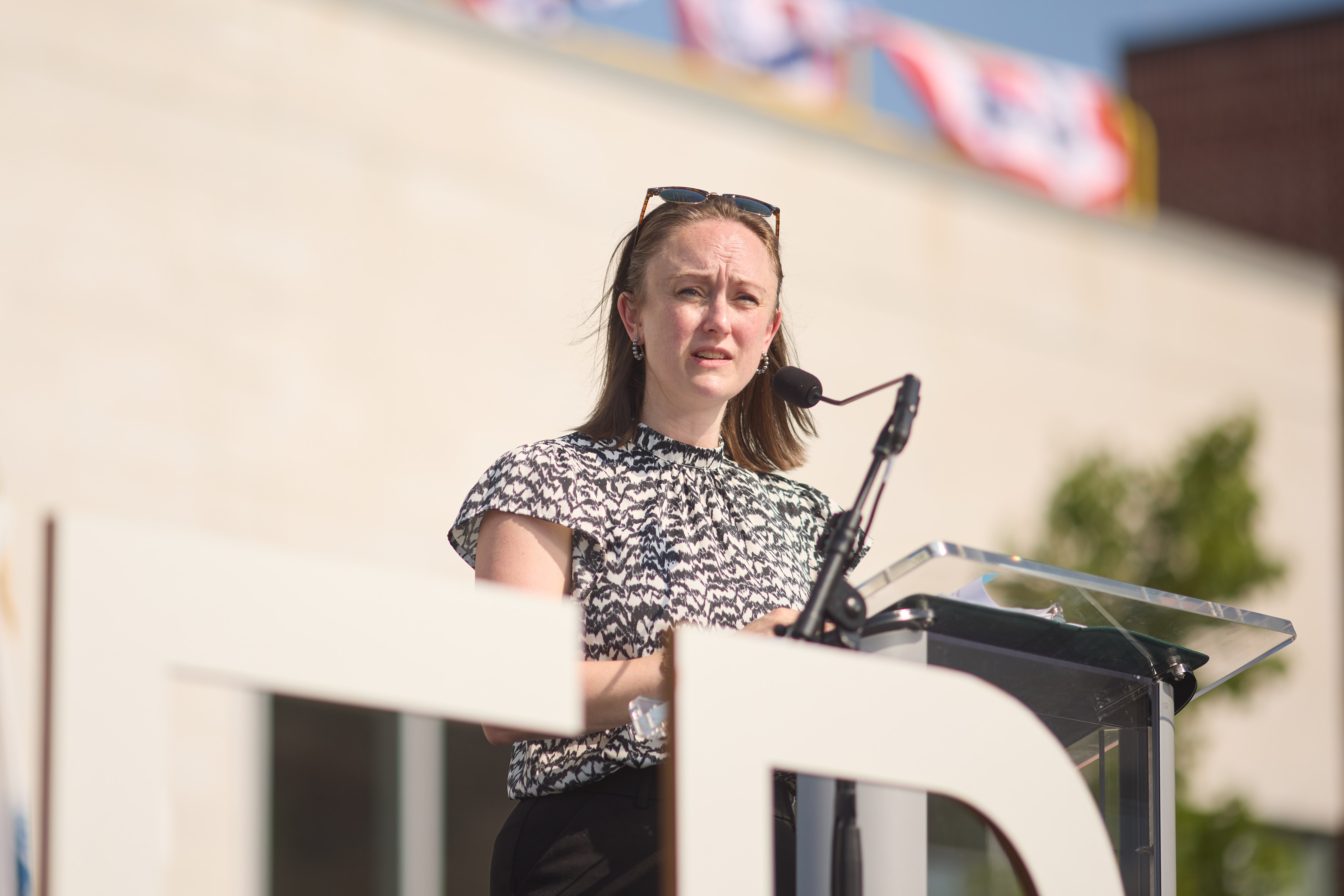 a woman speaks at the podium