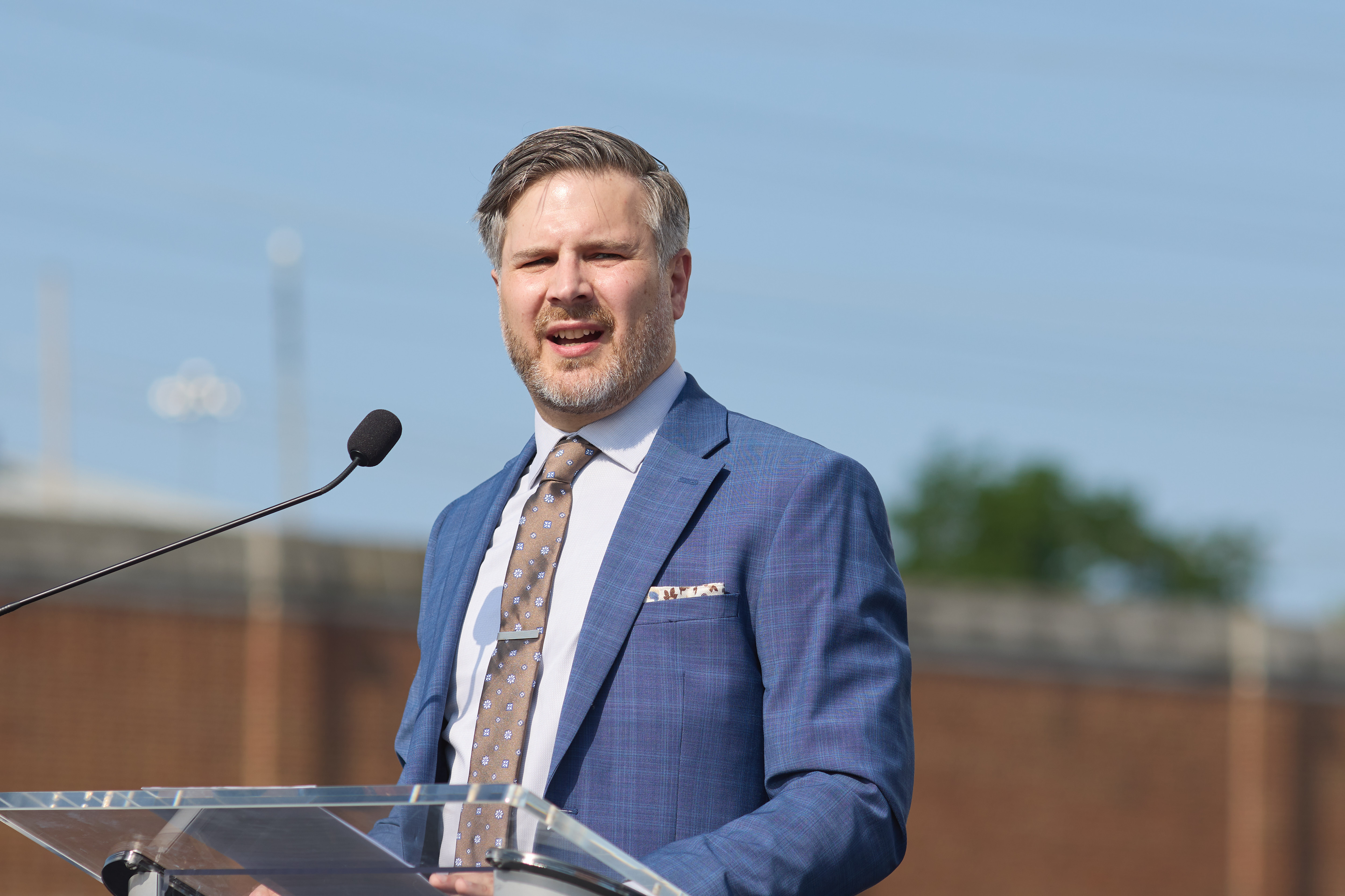 A man in a suit at the podium