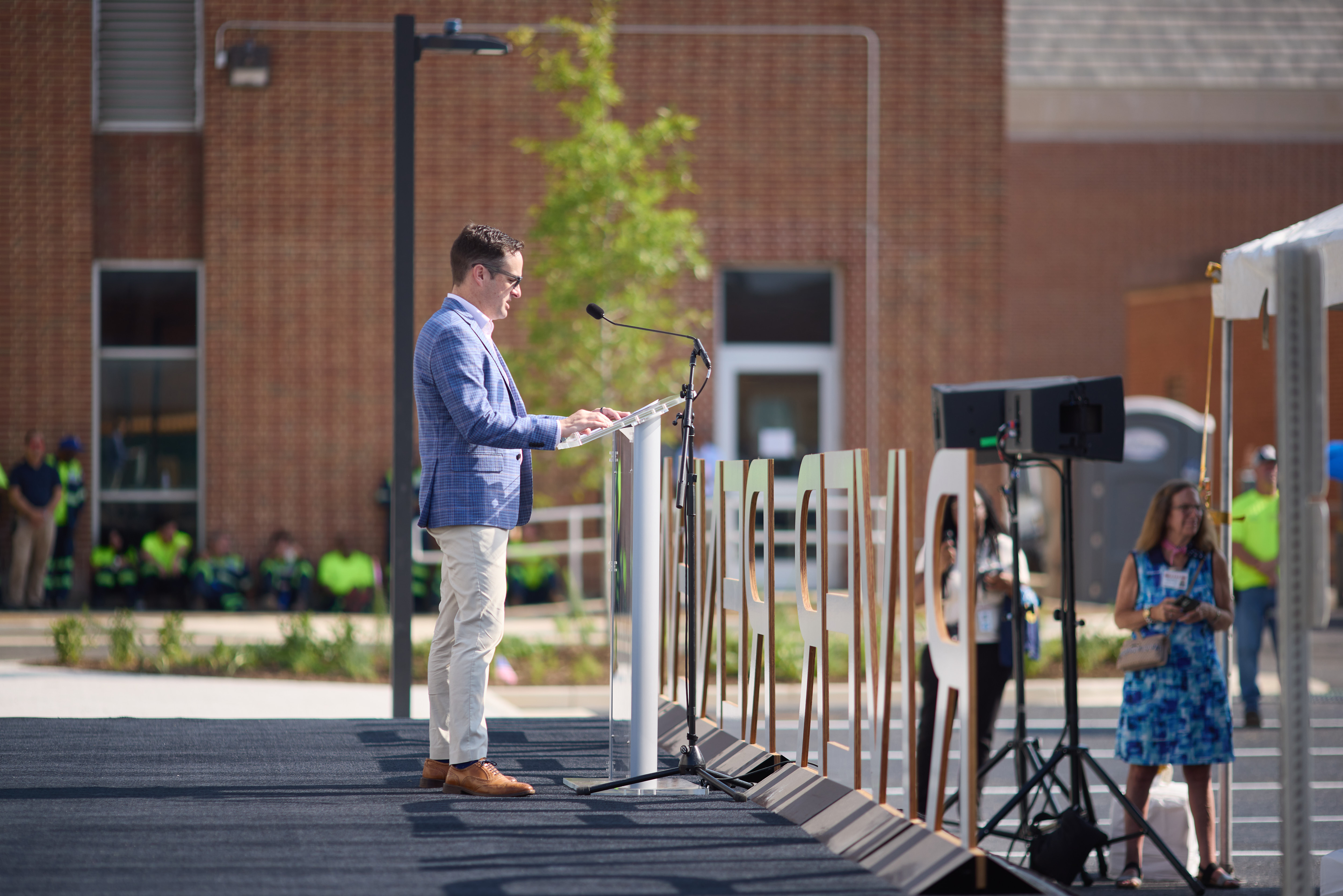 Profile view of a man speaking at the podium